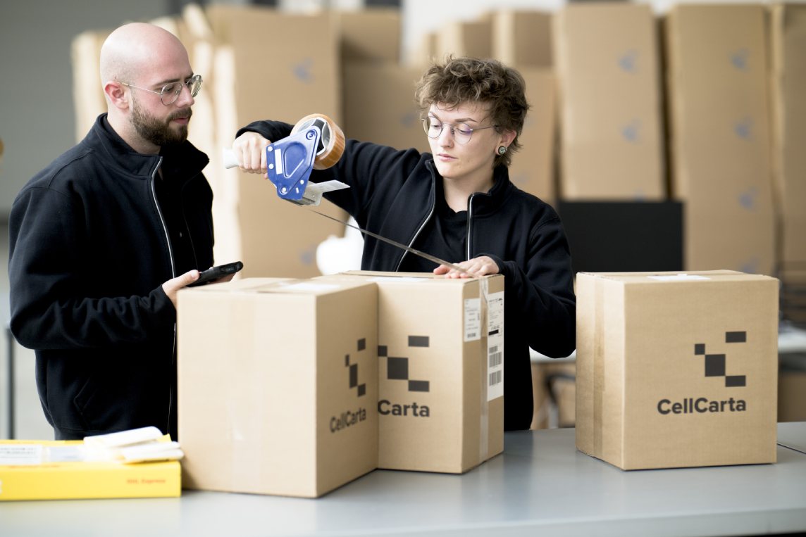 Team assembling clinical trial sample kits into CellCarta shipping boxes.