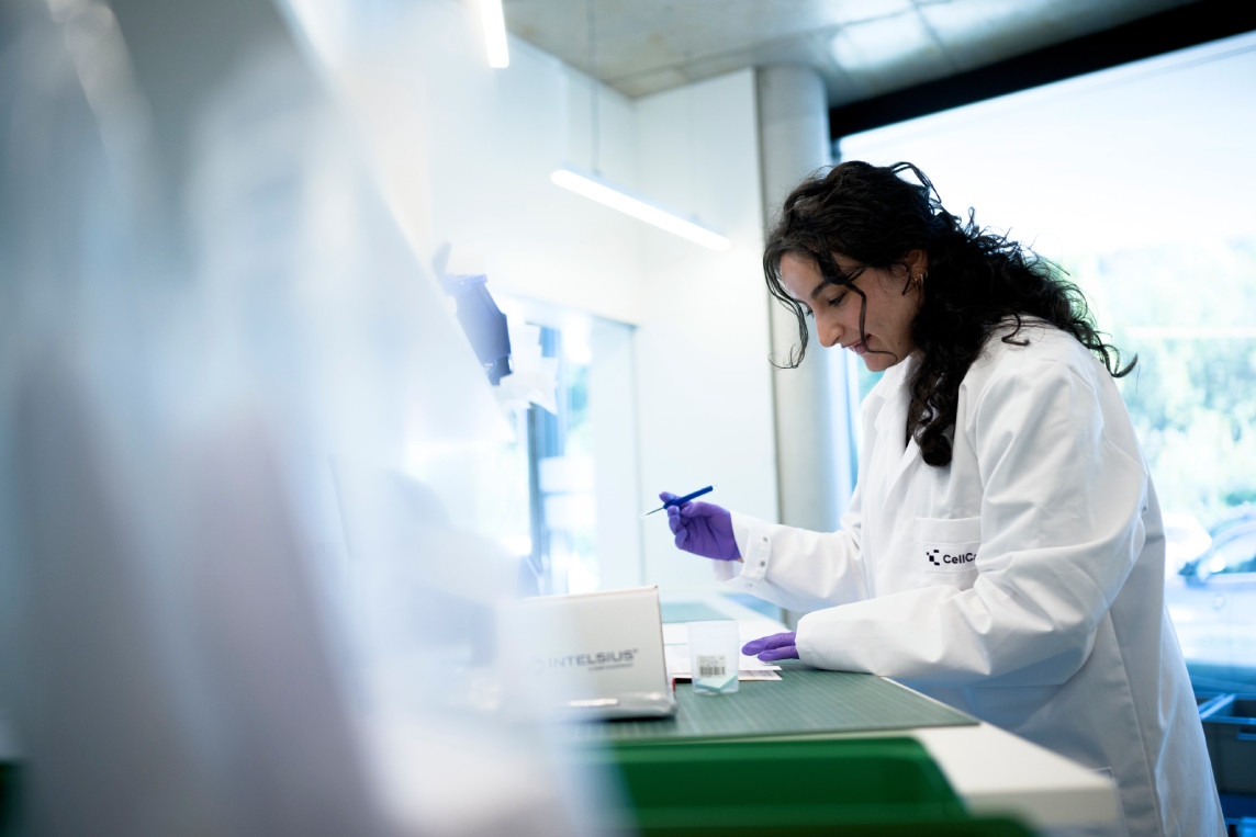 Scientist handling samples at a laboratory bench.