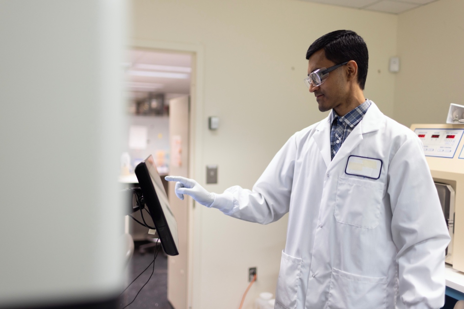 Scientist reviewing data on a tablet.
