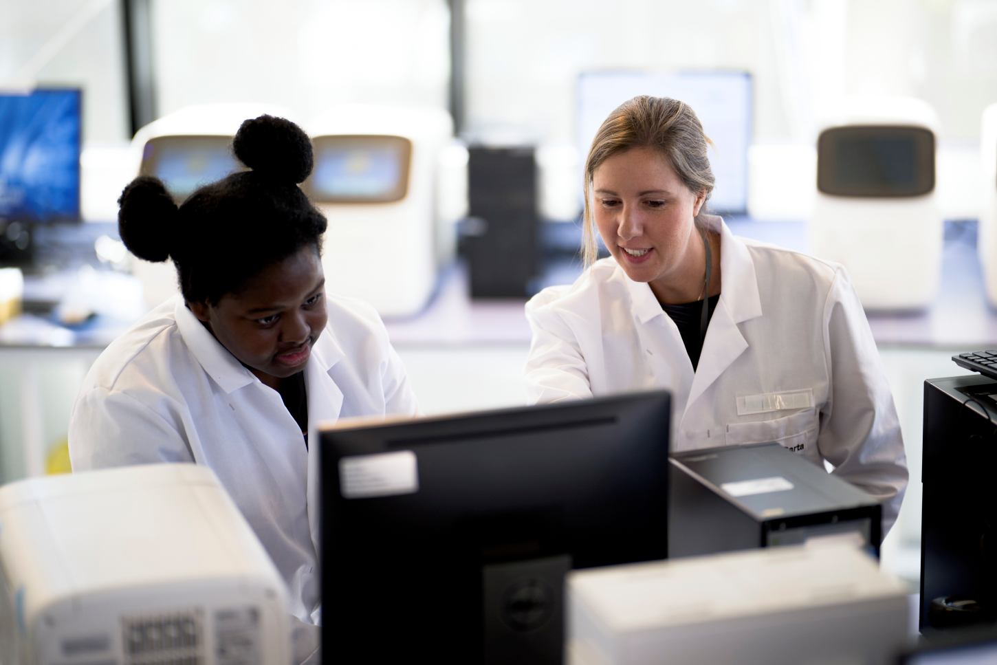 Scientists collaborating on custom Olink Flex panel design in laboratory