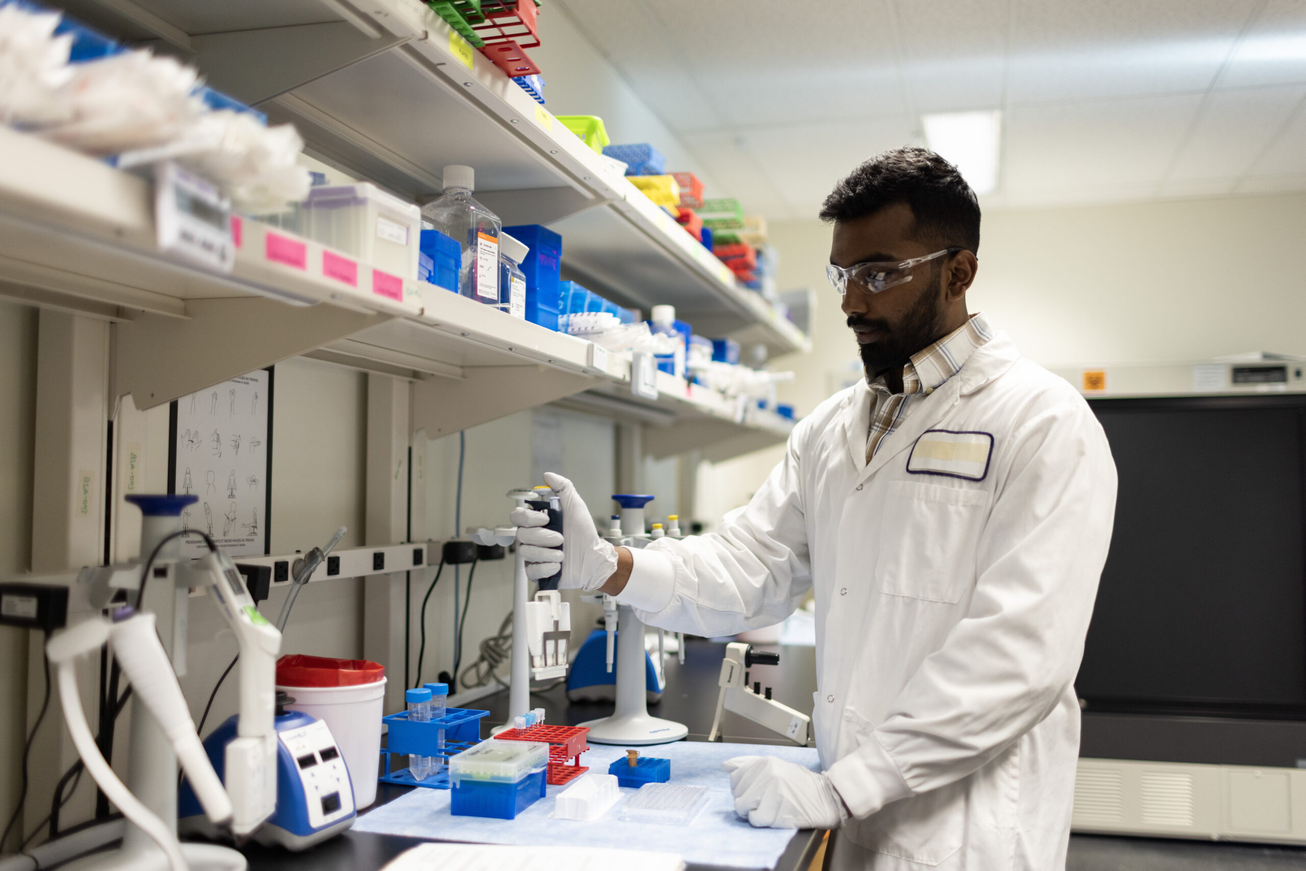Scientist working with laboratory instruments at the bench.