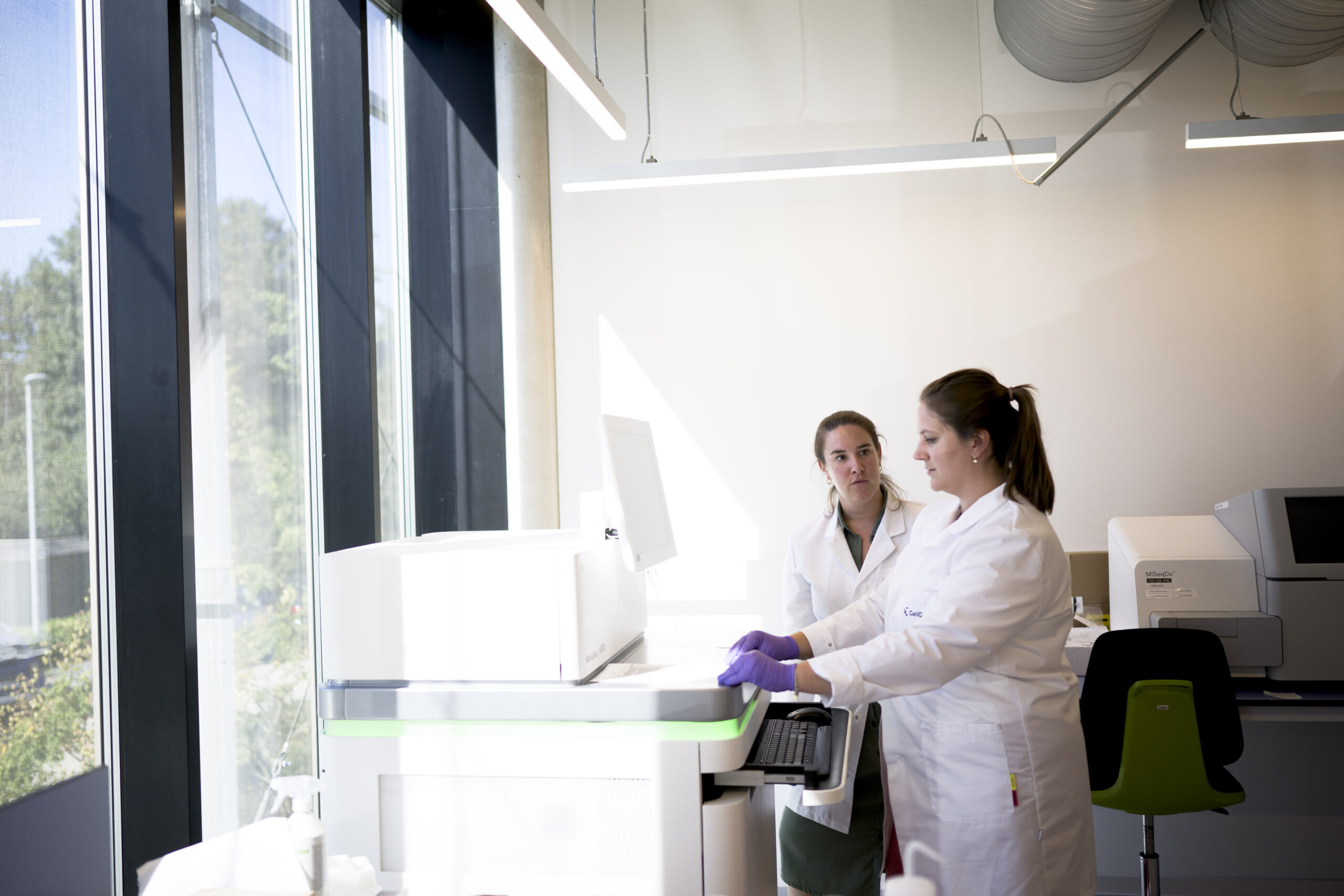 Scientists performing sequencing in a genomics laboratory.