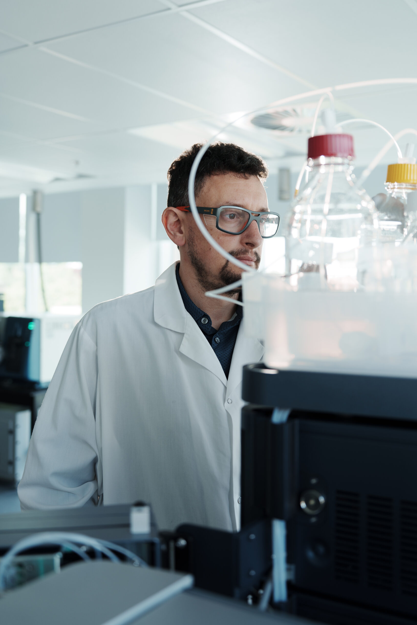Scientist operating LC-MS/MS instrument for discovery proteomics analysis