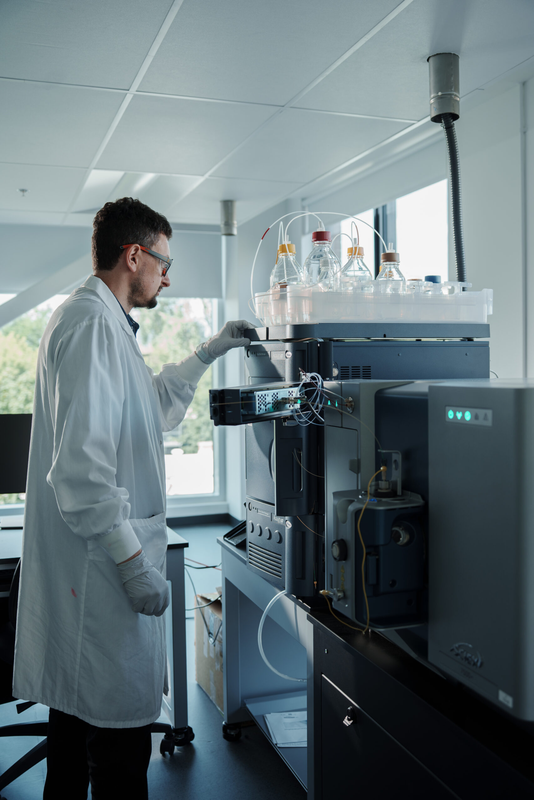 Scientist operating LC-MRM mass spectrometry system for targeted biomarker quantification