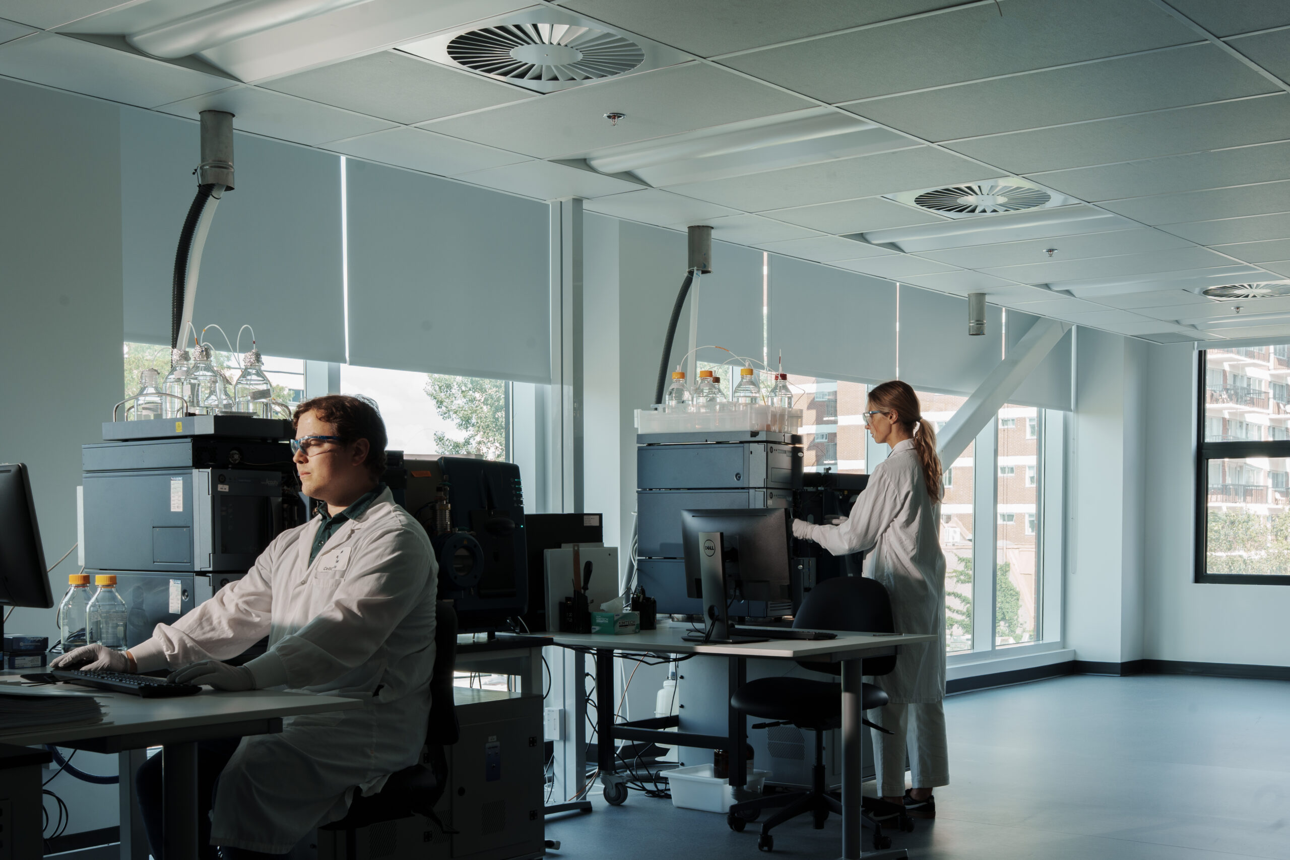 Scientists performing multiplexed LC-MRM/MS biomarker quantification.